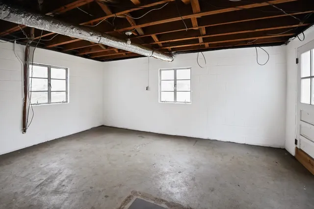 a view of a room with wooden walls and windows