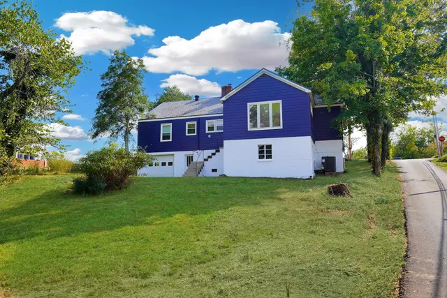 a view of a tree in front of a house