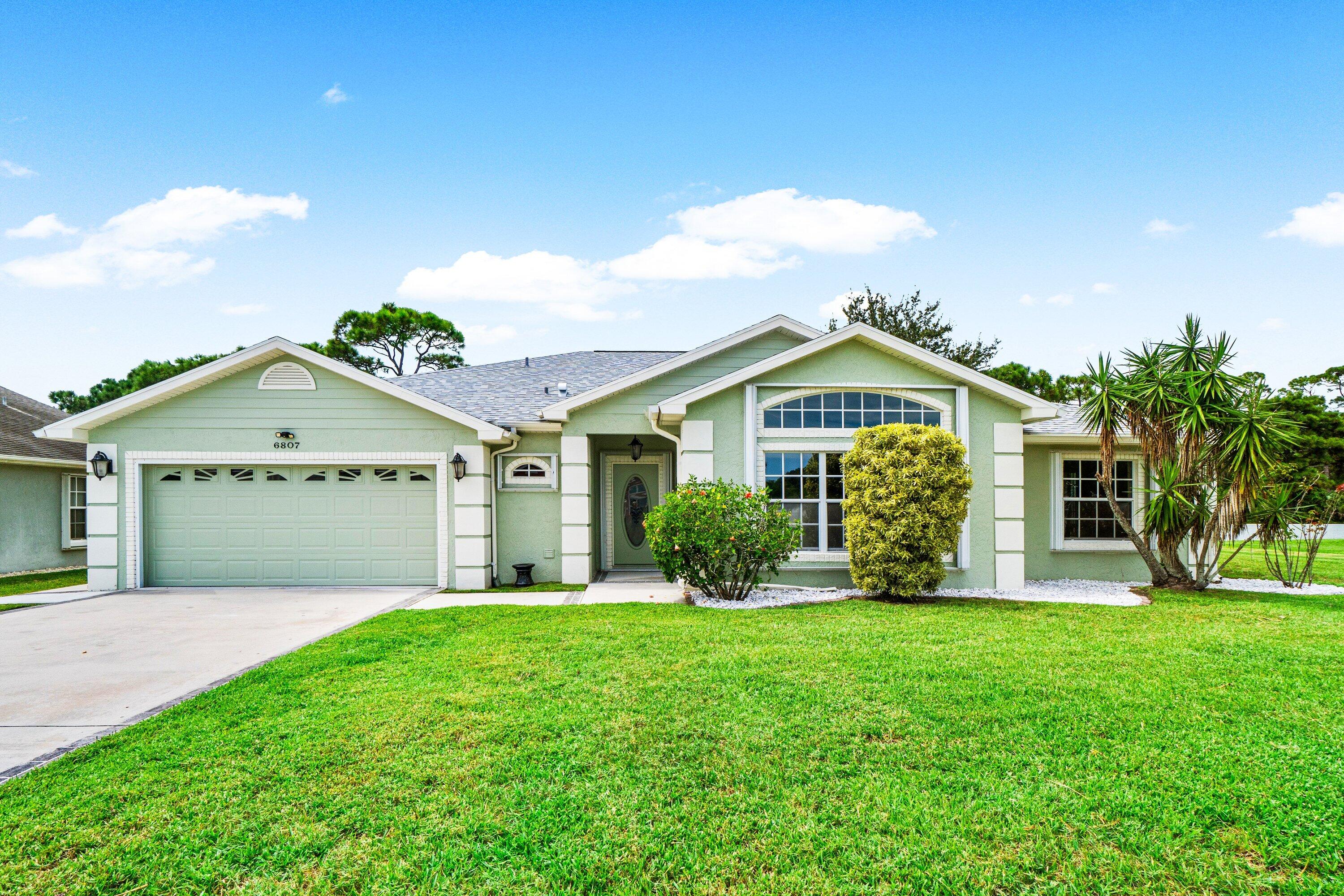 a front view of house with yard and green space