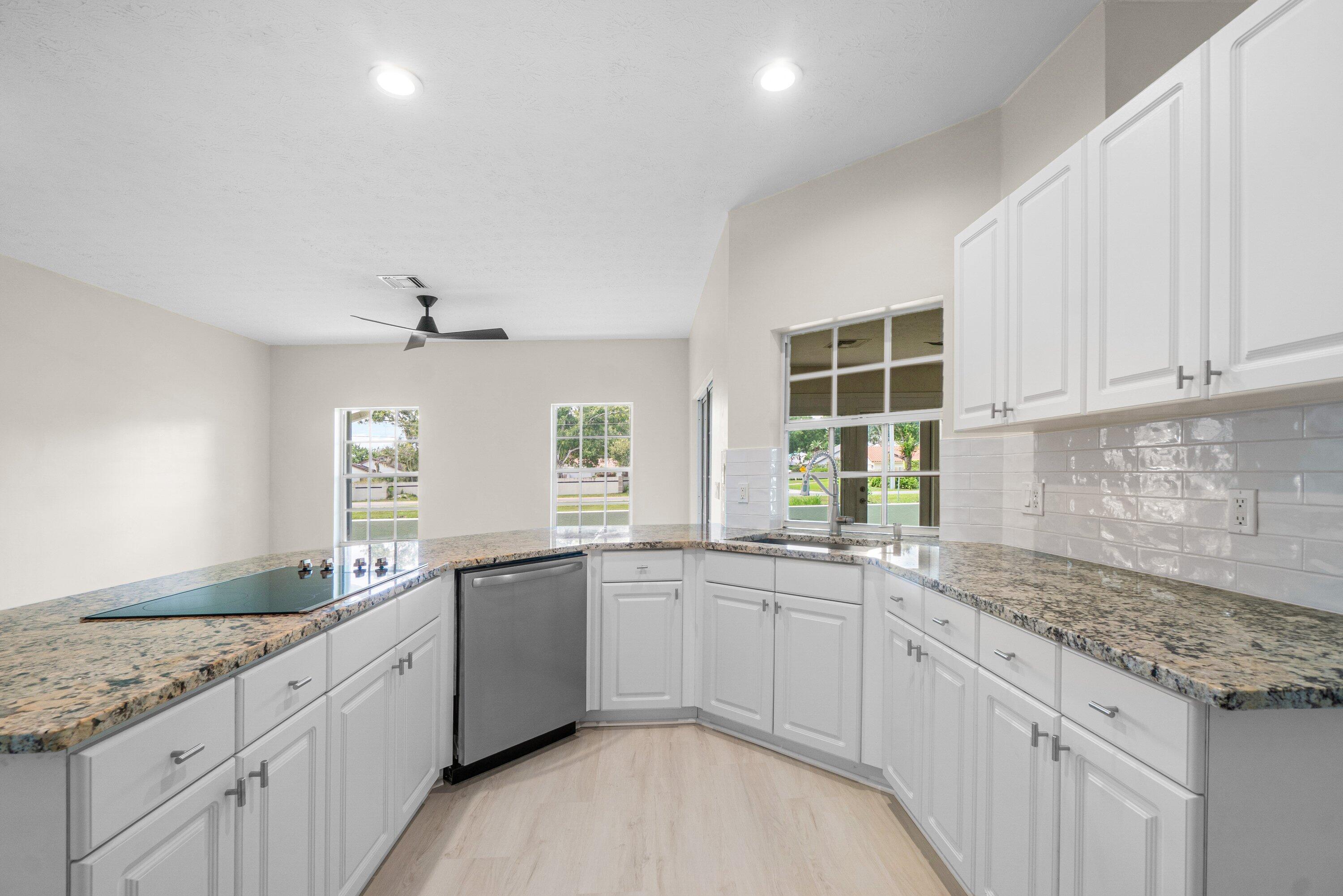 6807 Shelley Terrace Port St. Lucie, FL 34952 - Photo 11 of 34 a kitchen with a sink stove and cabinets