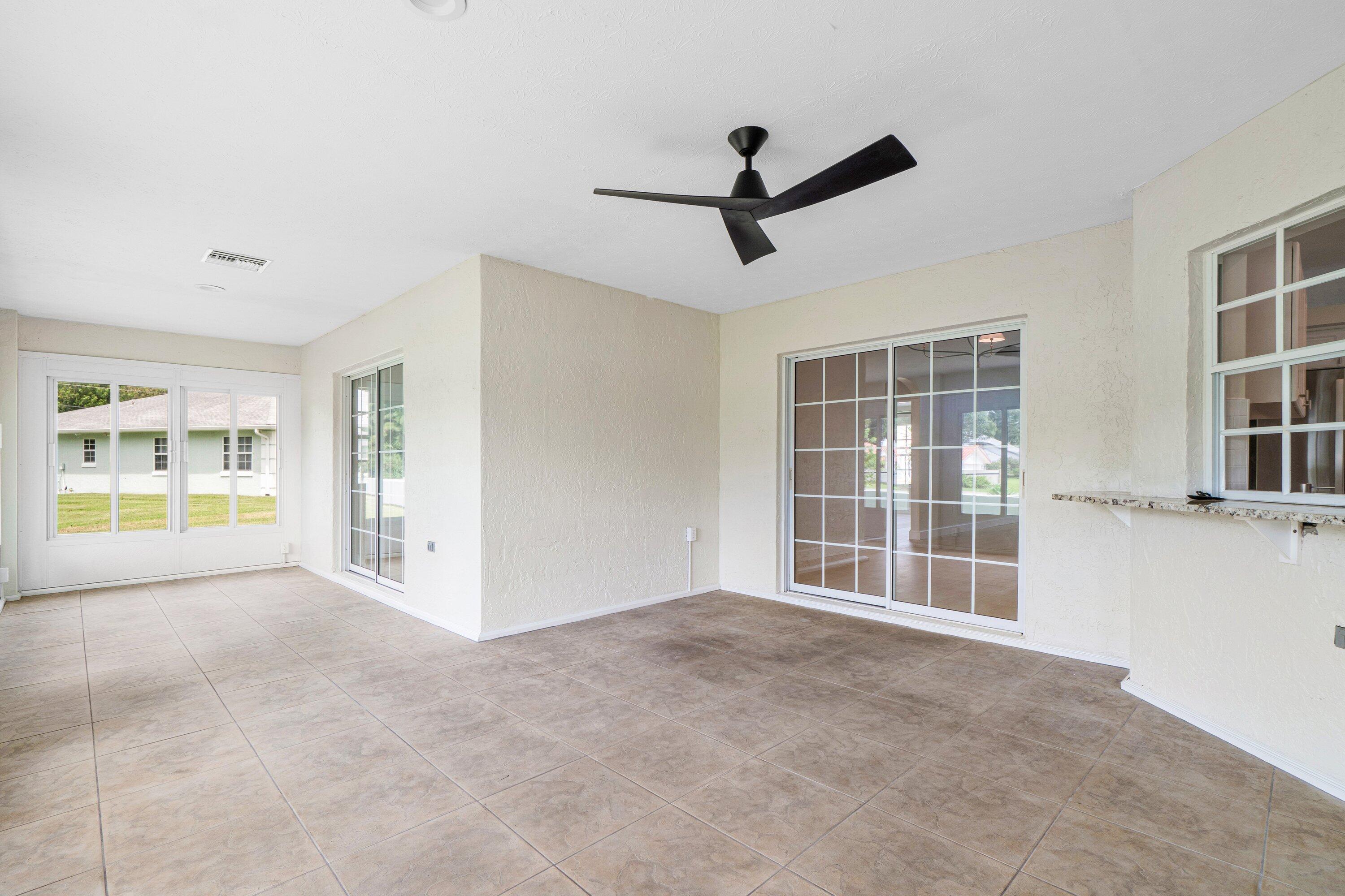 6807 Shelley Terrace Port St. Lucie, FL 34952 - Photo 17 of 34 a view of an empty room with a window and a kitchen area