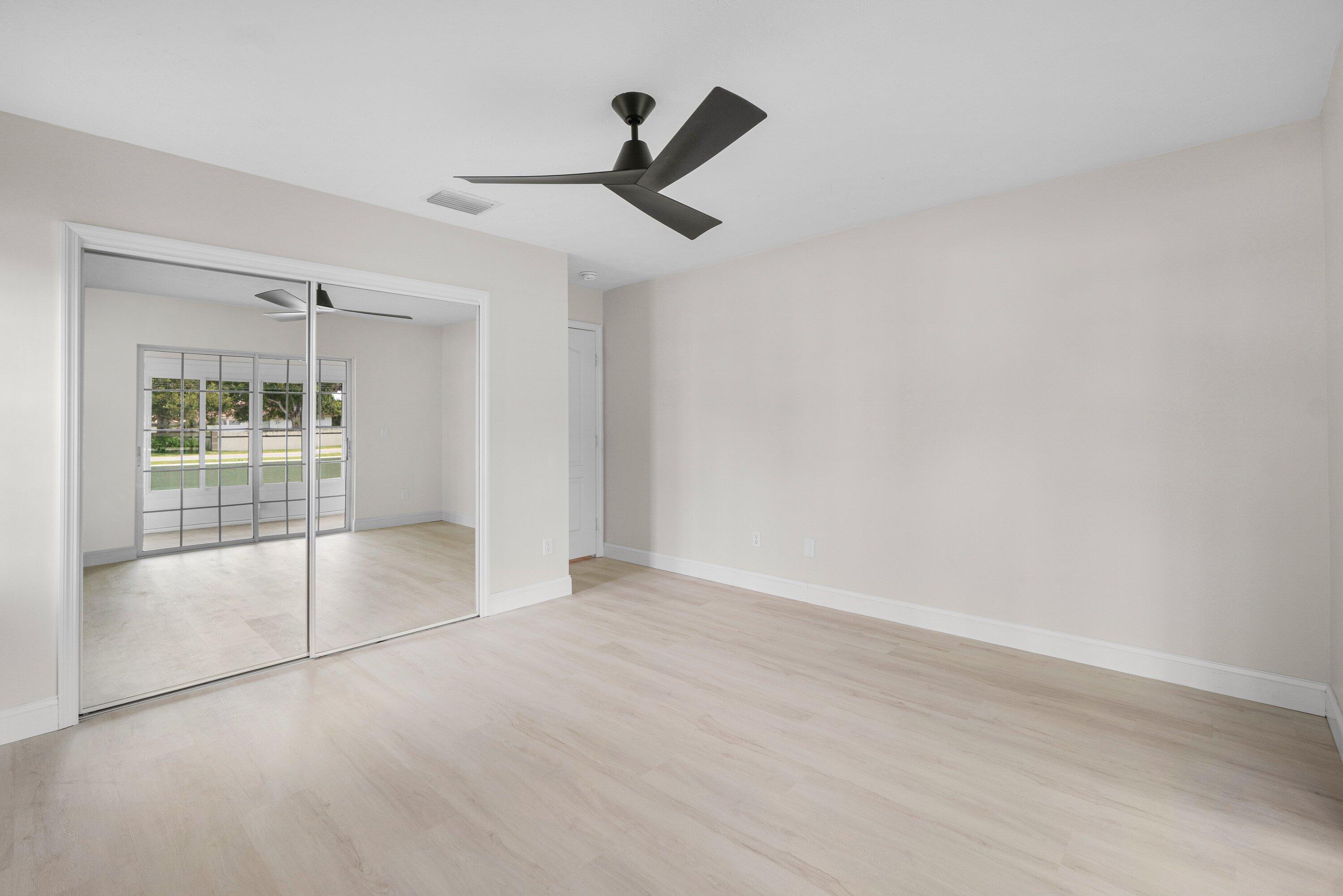 6807 Shelley Terrace Port St. Lucie, FL 34952 - Photo 22 of 34 an empty room with ceiling fan and windows