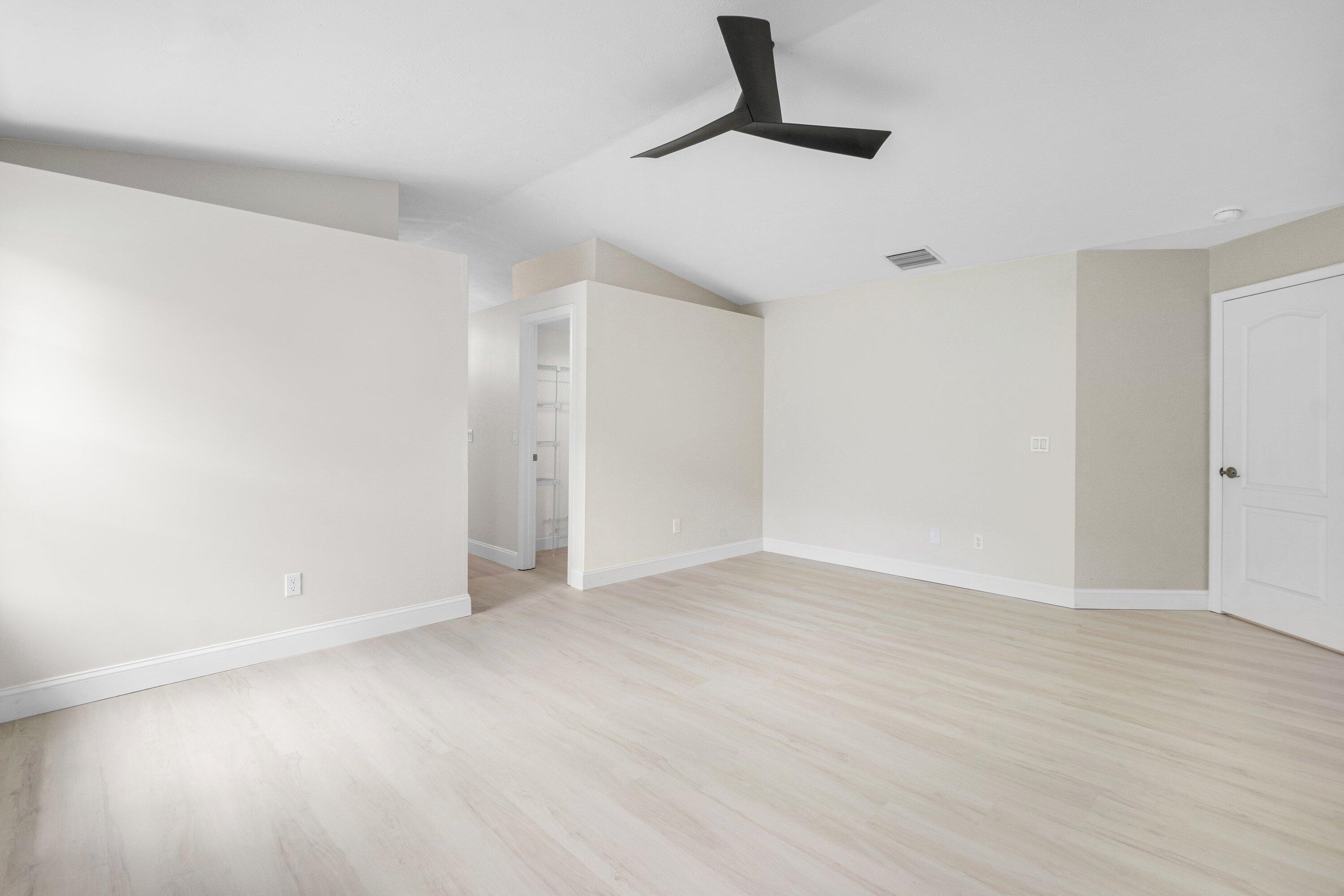 6807 Shelley Terrace Port St. Lucie, FL 34952 - Photo 24 of 34 a view of an empty room with wooden floor