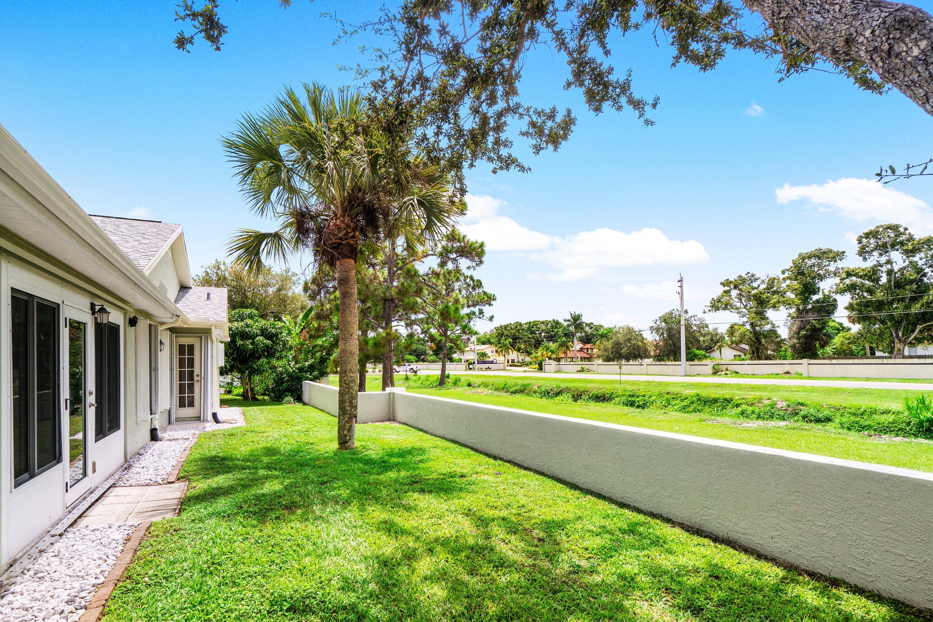 6807 Shelley Terrace Port St. Lucie, FL 34952 - Photo 34 of 34 a view of a big yard with potted plants and big trees