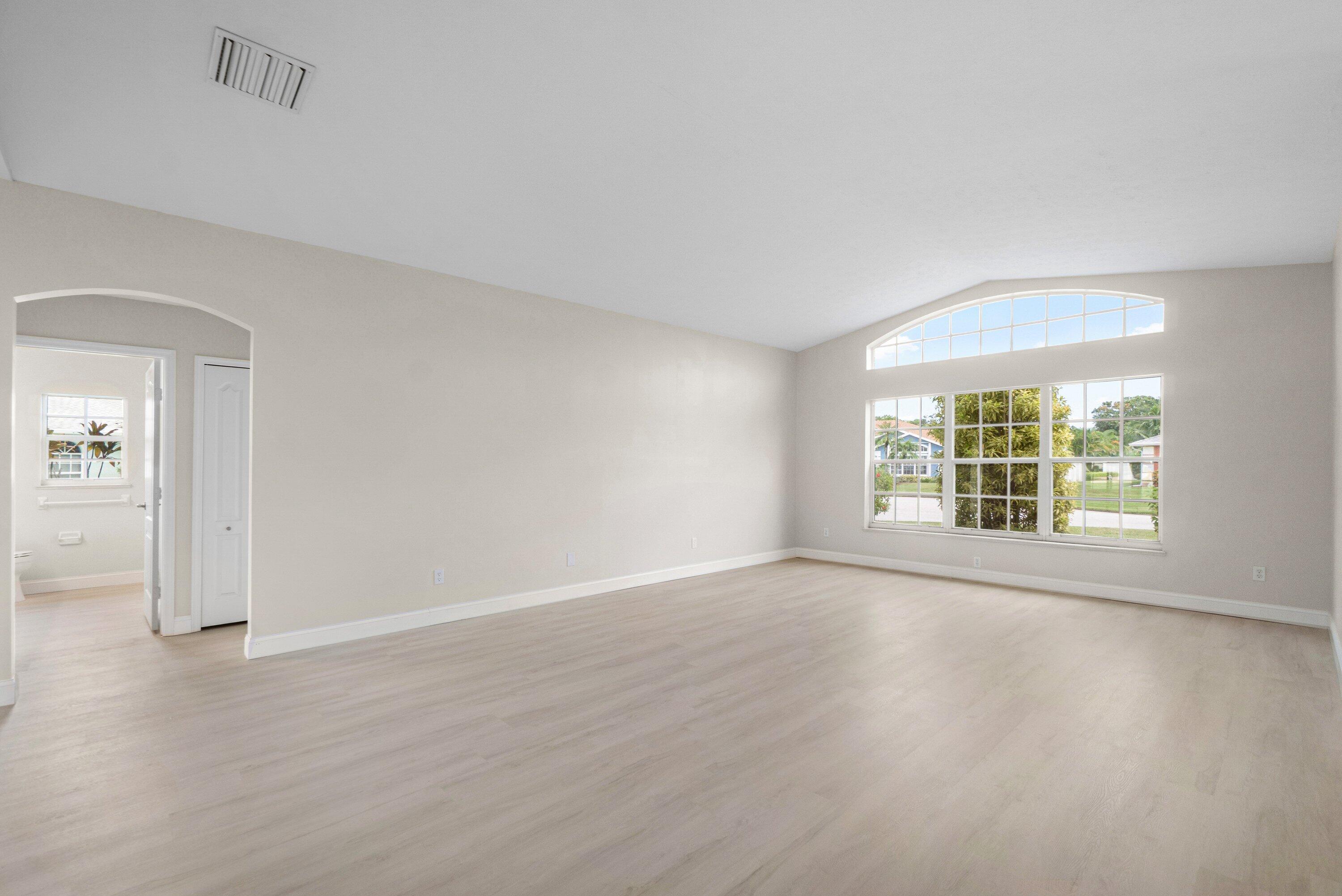 6807 Shelley Terrace Port St. Lucie, FL 34952 - Photo 4 of 34 an empty room with wooden floor and windows
