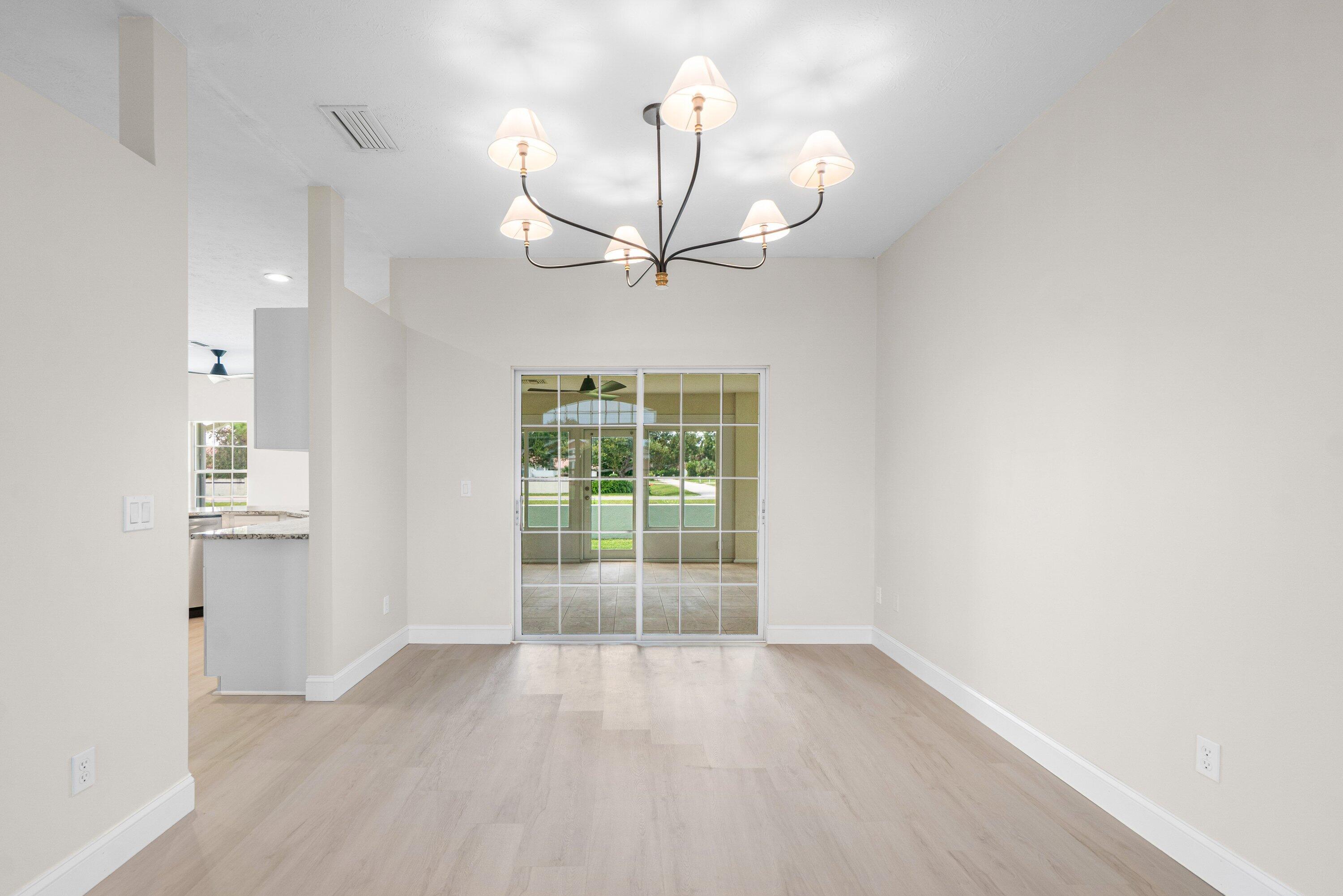 6807 Shelley Terrace Port St. Lucie, FL 34952 - Photo 5 of 34 wooden floor in an empty room with a window