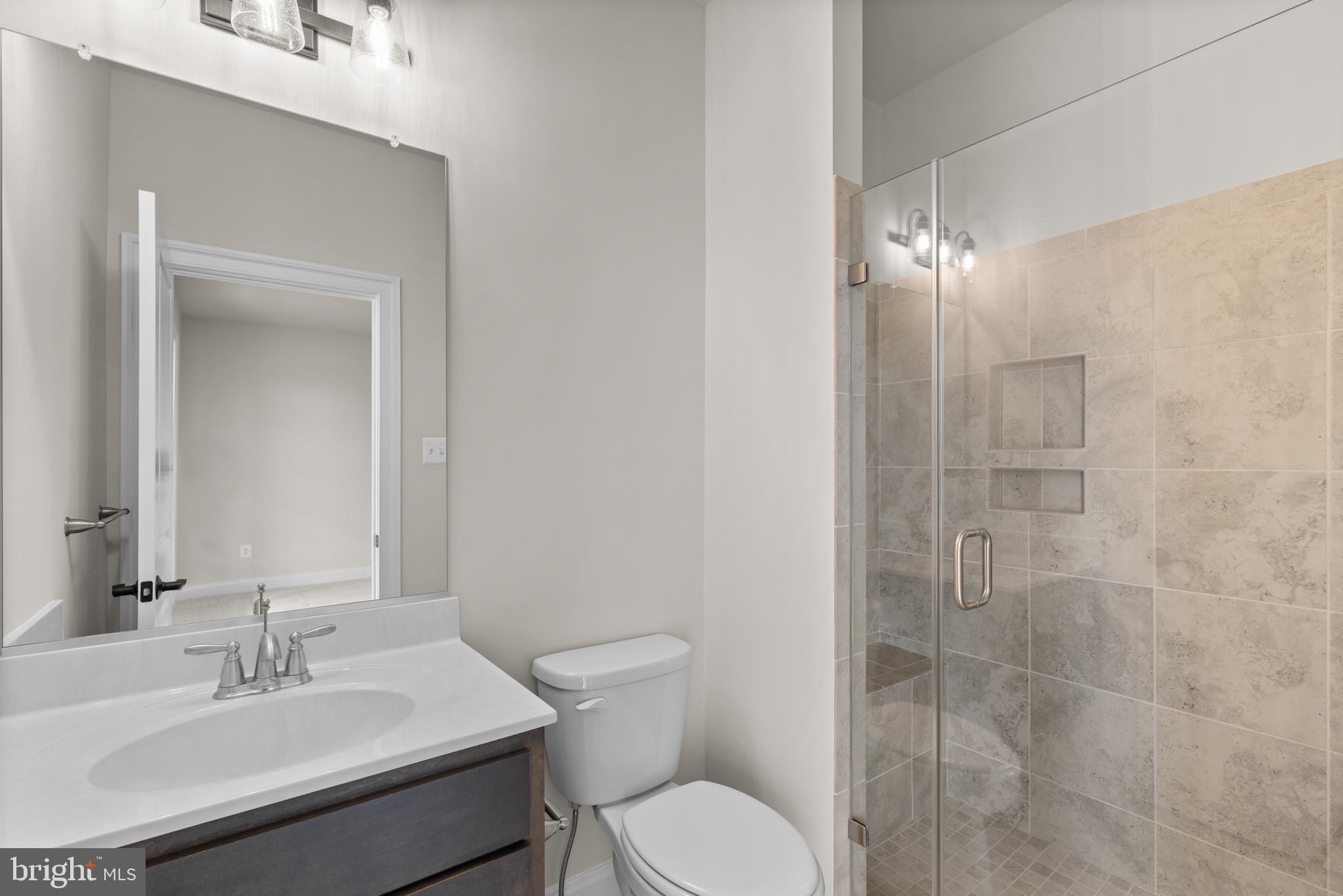 14628 Old Hanover Road, Unit REGINA Reisterstown, MD 21136 - Photo 42 of 67 a bathroom with a sink toilet and shower