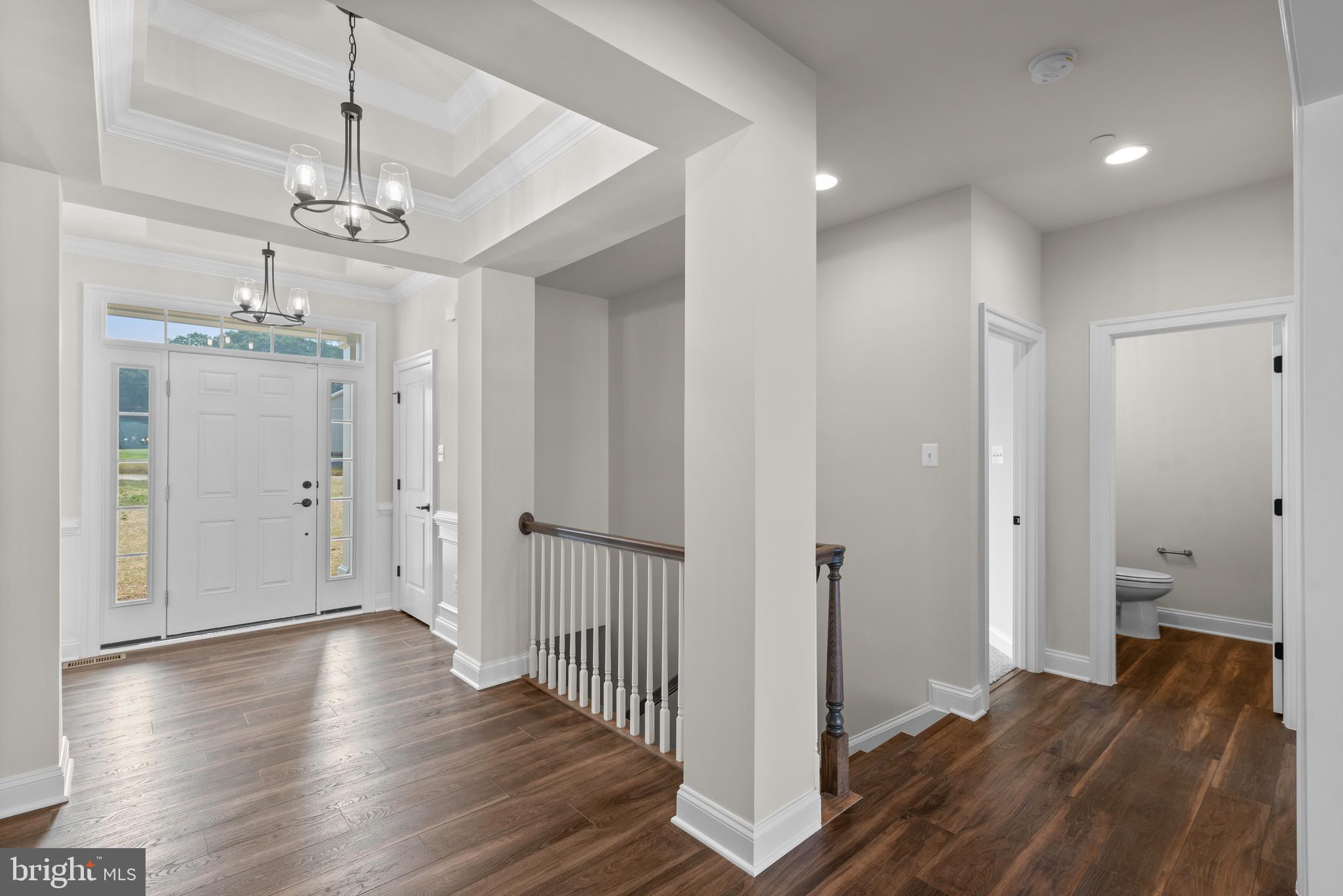 14628 Old Hanover Road, Unit REGINA Reisterstown, MD 21136 - Photo 5 of 67 a view of a hallway with wooden floor and staircase