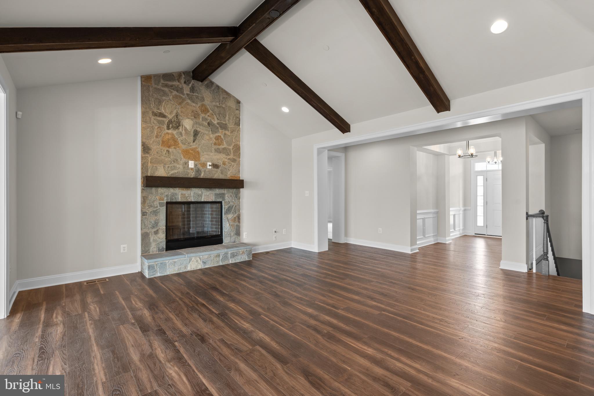 14628 Old Hanover Road, Unit REGINA Reisterstown, MD 21136 - Photo 9 of 67 a view of an empty room with wooden floor fireplace and a window