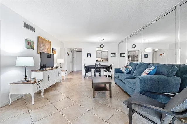 a living room with furniture and a lamp