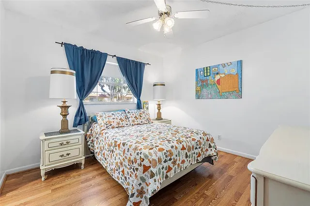 a bedroom with a bed and a painting on the wall