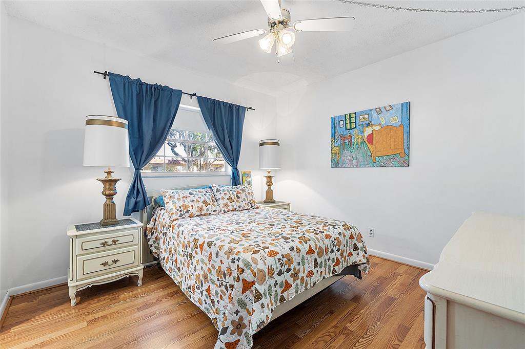 5621 Southwest 2nd Court, Unit 201 Margate, FL 33068 - Photo 4 of 17 a bedroom with a bed and a painting on the wall