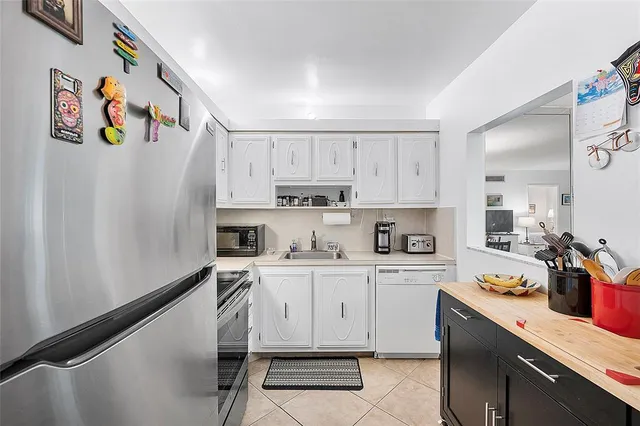 a kitchen with stainless steel appliances a stove a sink and cabinets