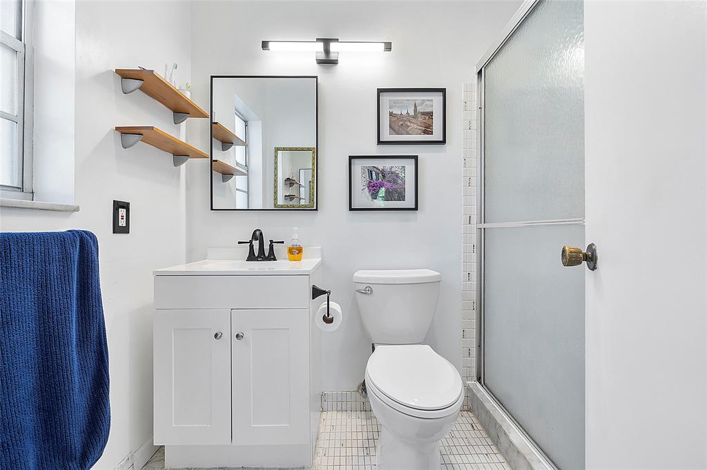 5621 Southwest 2nd Court, Unit 201 Margate, FL 33068 - Photo 10 of 17 a bathroom with a toilet sink and mirror