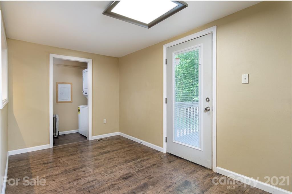 1373 Coopers Gap Road Mill Spring, NC 28756 - Photo 22 of 44 a view of an empty room with wooden floor and a window