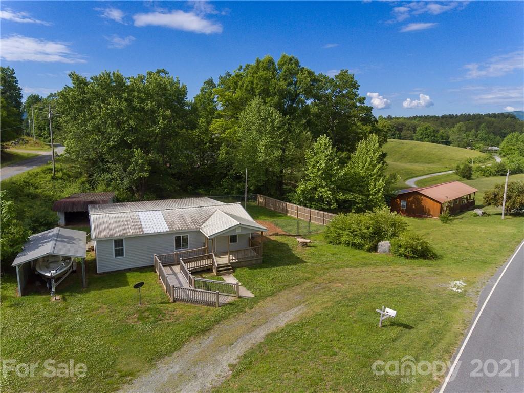 1373 Coopers Gap Road Mill Spring, NC 28756 - Photo 4 of 44 an aerial view of a house with swimming pool outdoor seating and yard