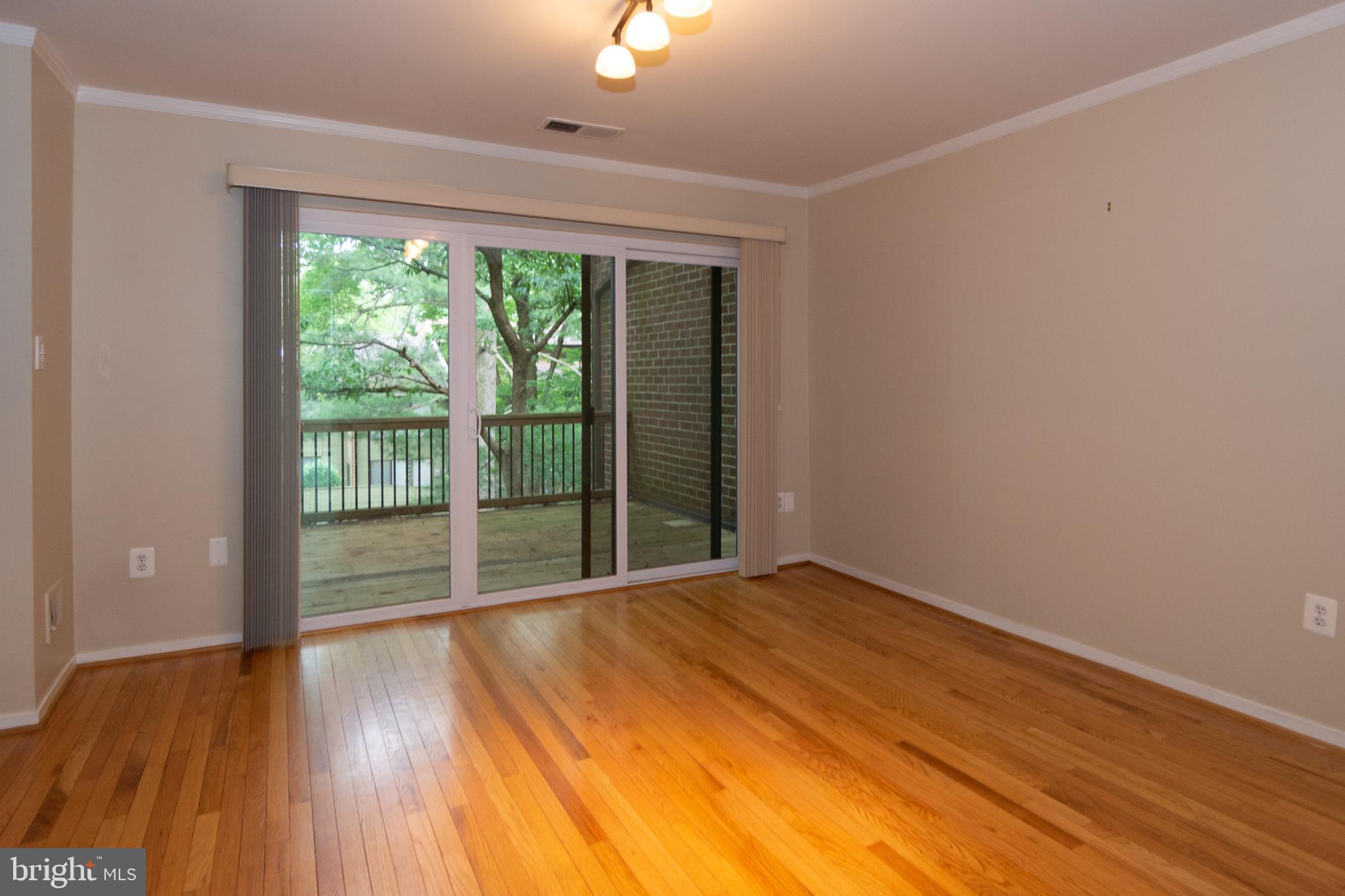11768 Indian Ridge Road Reston, VA 20191 - Photo 27 of 57 a view of an empty room with wooden floor and a window