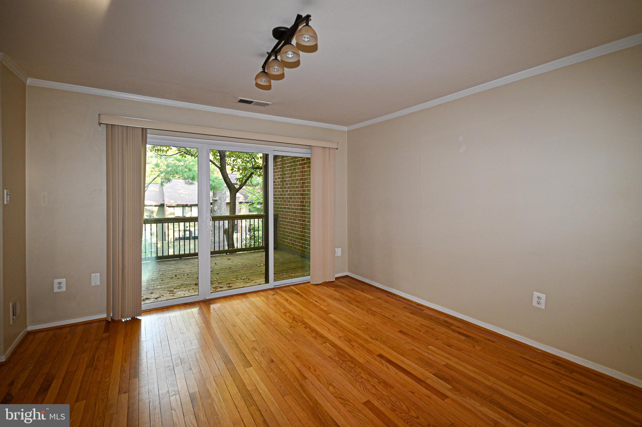 11768 Indian Ridge Road Reston, VA 20191 - Photo 55 of 57 a view of an empty room with wooden floor and a window