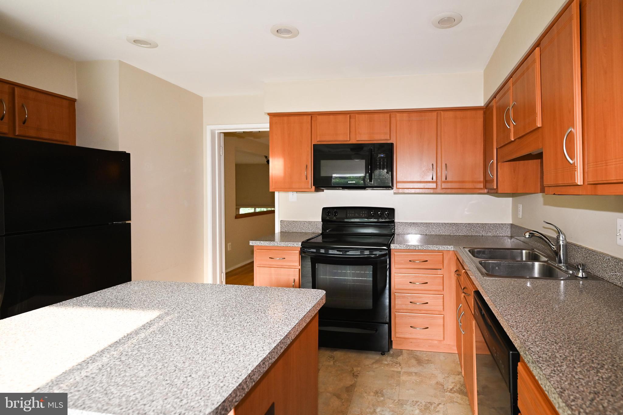 11768 Indian Ridge Road Reston, VA 20191 - Photo 56 of 57 a kitchen with stainless steel appliances granite countertop a sink stove and refrigerator