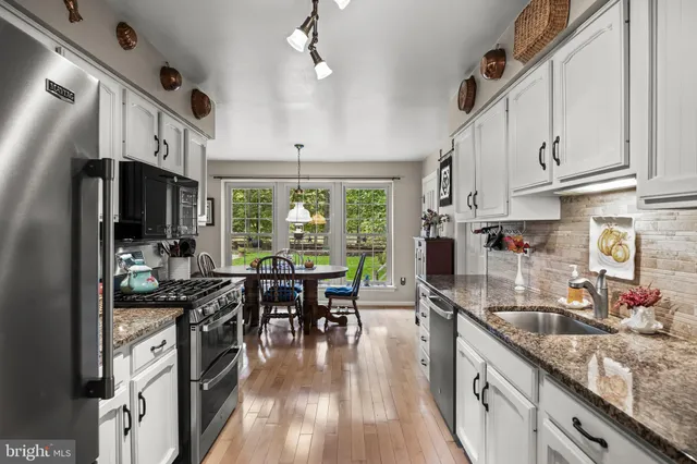 a kitchen with granite countertop lots of counter top space and stainless steel appliances