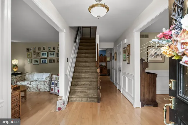 a view of entryway and hall with wooden floor