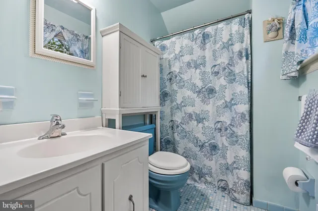 a bathroom with a sink mirror and toilet