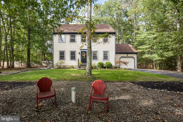 a view of a house with backyard sitting area and garden