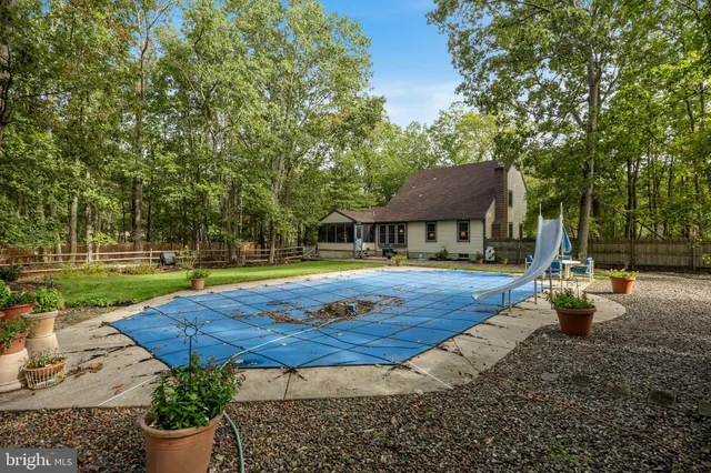 a view of a house with swimming pool and sitting area