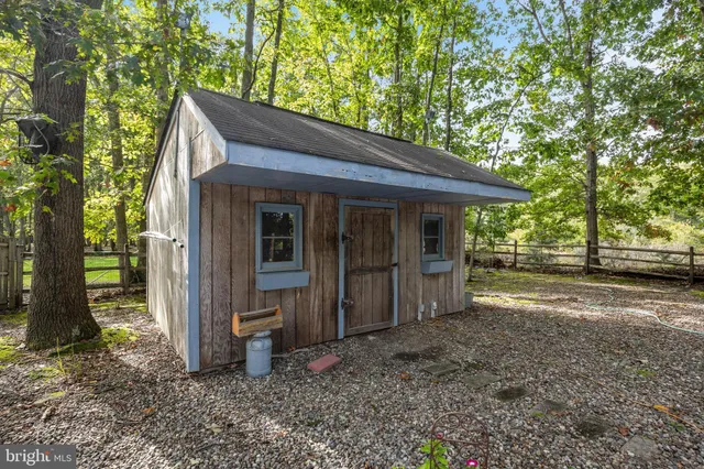 a backyard of a house with barbeque oven table and chairs