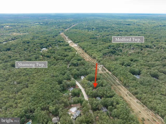 a view of a field with an ocean and mountain view