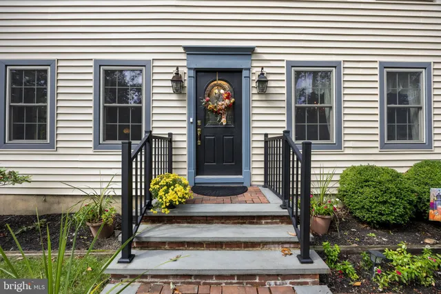 a front view of a house with potted plants