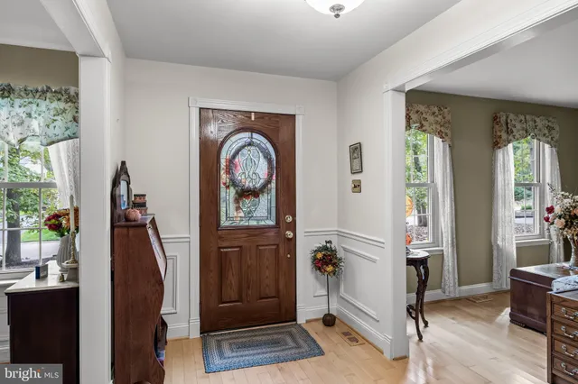 a view of a entryway door with wooden floor