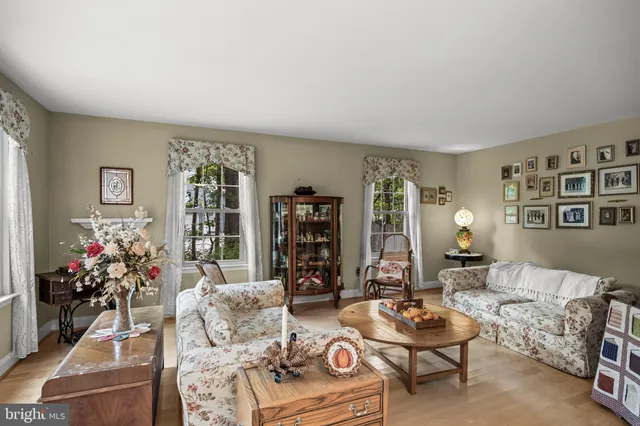 a living room with furniture and flowers