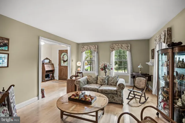 a living room with furniture couches and a large window with garden view