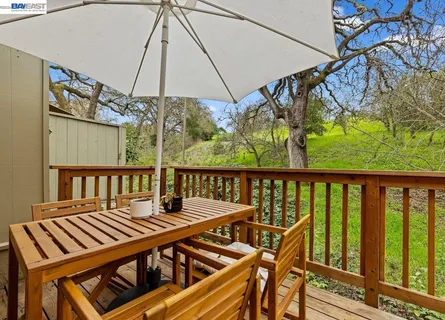 a view of a balcony with wooden floor and outdoor seating