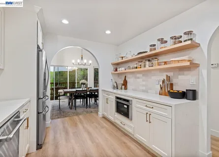 a kitchen with stainless steel appliances granite countertop a stove and a sink