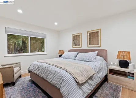 a bedroom with a large bed and a window