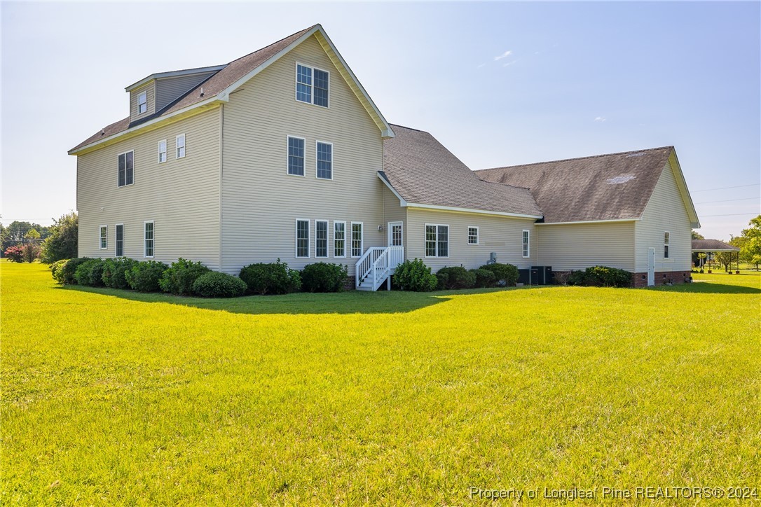 1591 Shannon Road Lumberton, NC 28360 - Photo 5 of 12 a front view of house with yard and outdoor seating