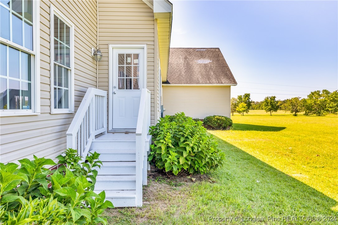 1591 Shannon Road Lumberton, NC 28360 - Photo 6 of 12 a view of a house with a yard