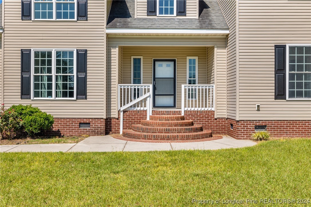 1591 Shannon Road Lumberton, NC 28360 - Photo 7 of 12 a front view of a house with a yard