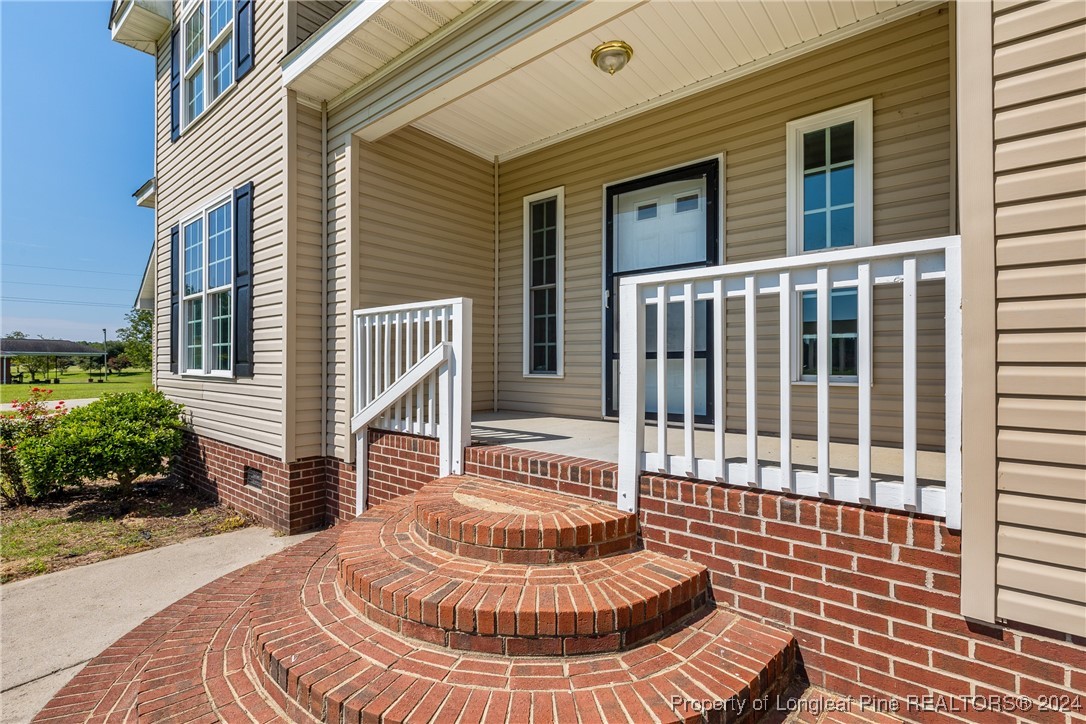 1591 Shannon Road Lumberton, NC 28360 - Photo 8 of 12 a front view of a house with a fountain