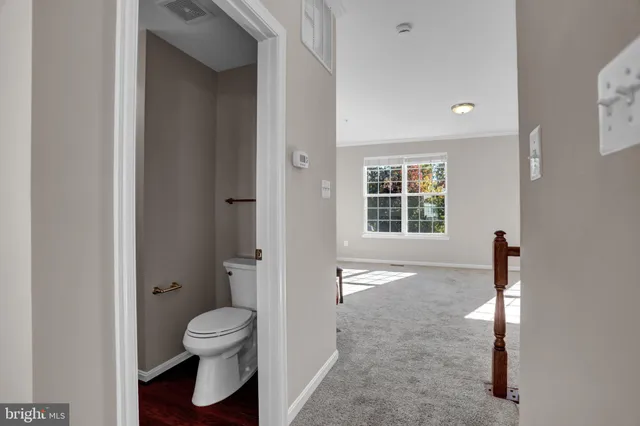 a bathroom with a toilet a sink and a mirror