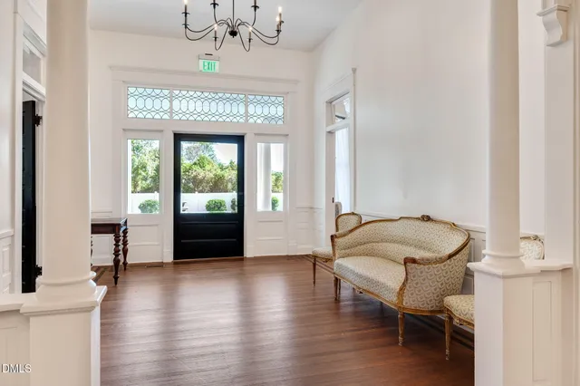 an entryway at livingroom with furniture wooden floor and window