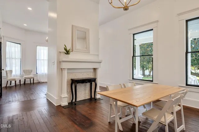a view of a hallway with wooden floor and entryway