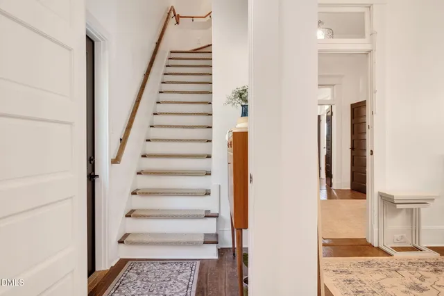 a front view of a house with a yard table and chairs