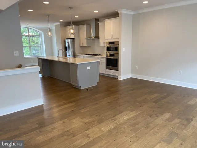 a large kitchen with kitchen island a sink stainless steel appliances and cabinets