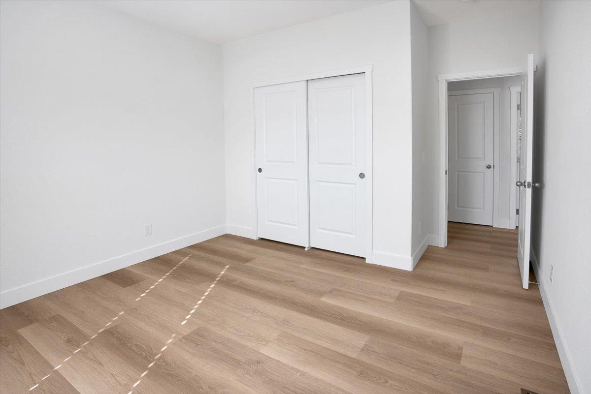 144 Holm Road, Unit 55 Watsonville, CA 95076 - Photo 18 of 24 a view of an empty room with wooden floor