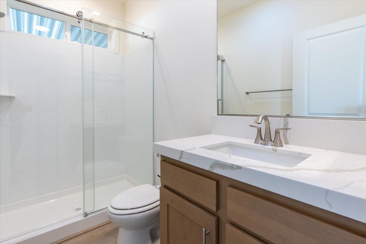 144 Holm Road, Unit 55 Watsonville, CA 95076 - Photo 19 of 24 a bathroom with a sink toilet and shower