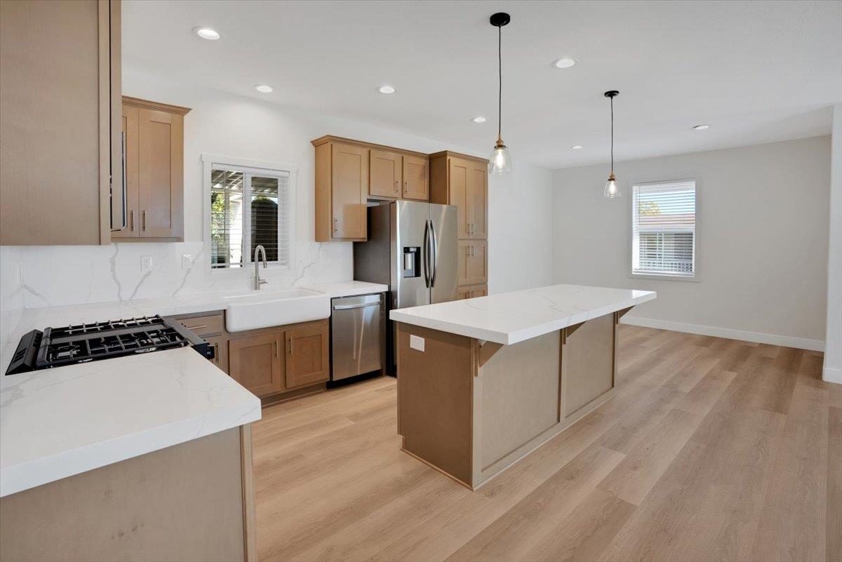 144 Holm Road, Unit 55 Watsonville, CA 95076 - Photo 5 of 24 a kitchen with a sink stove and refrigerator