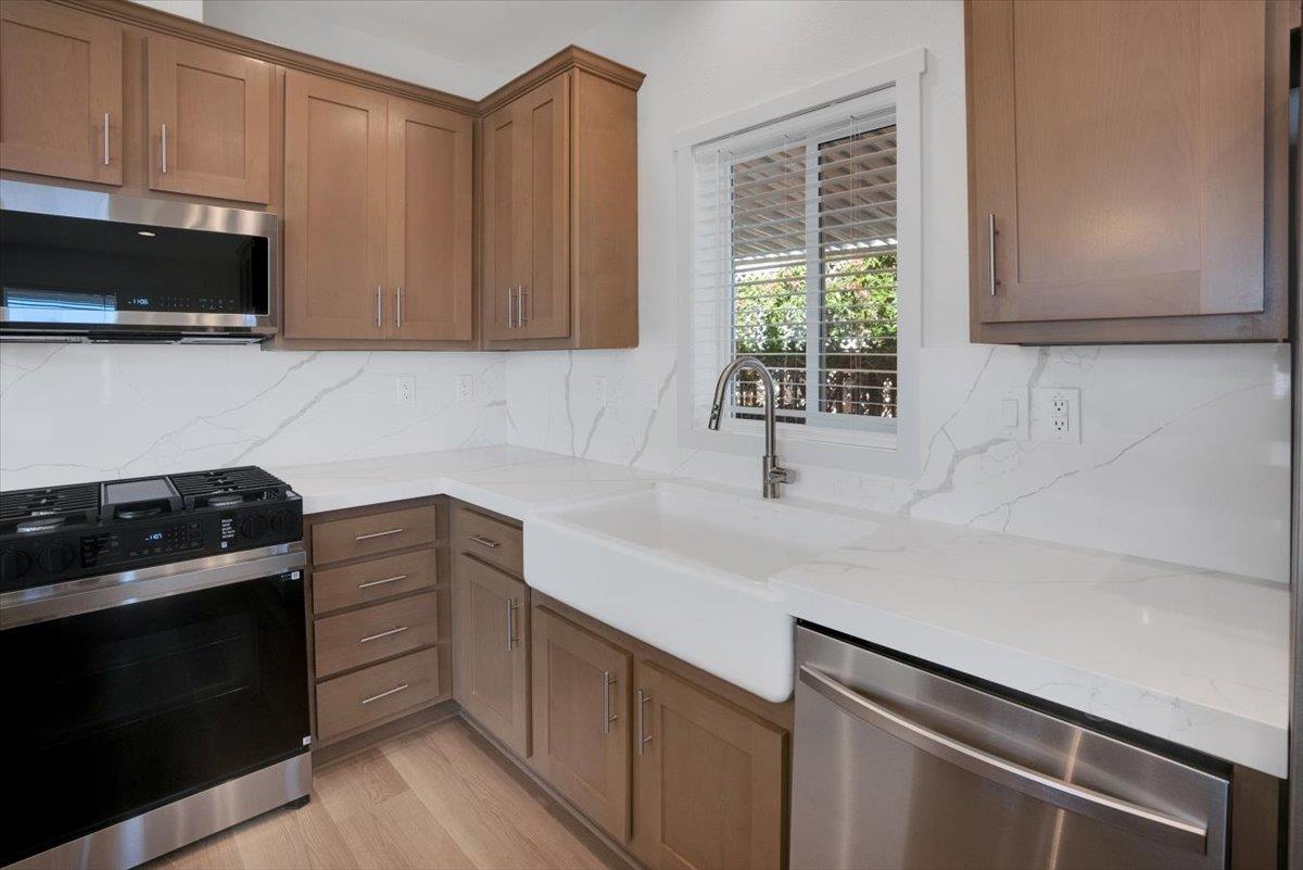 144 Holm Road, Unit 55 Watsonville, CA 95076 - Photo 7 of 24 a kitchen with a sink and a stove top oven
